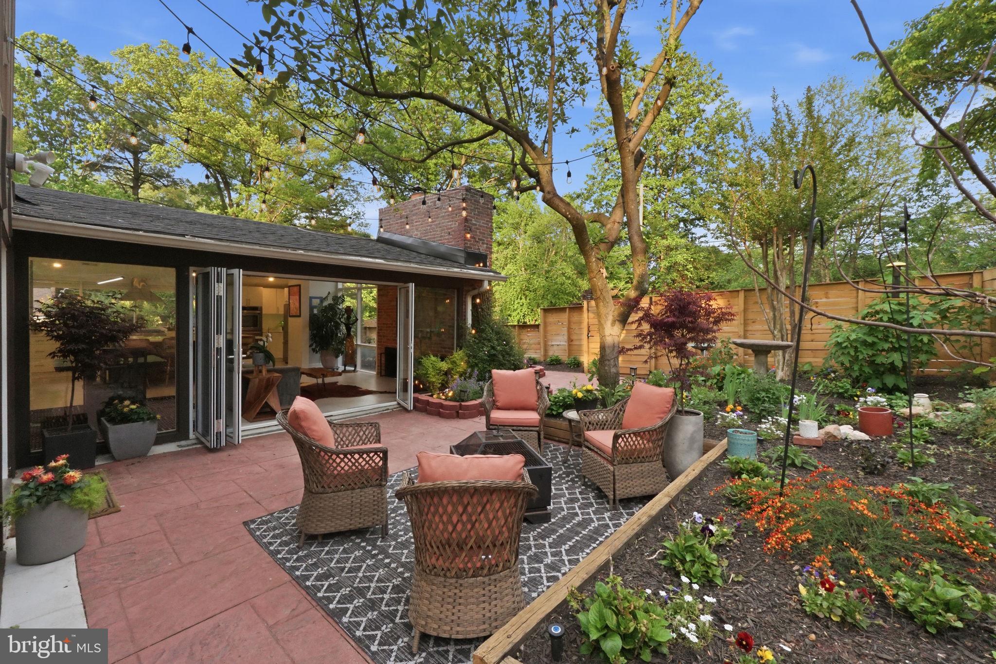 3311 Pendleton Drive Silver Spring, MD 20902 - Photo 5 of 45 a view of a patio with couches potted plants and a large tree