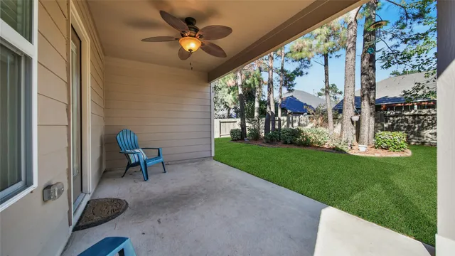 a view of a porch with chairs and a yard