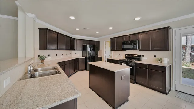 a kitchen with stainless steel appliances a stove sink microwave and cabinets