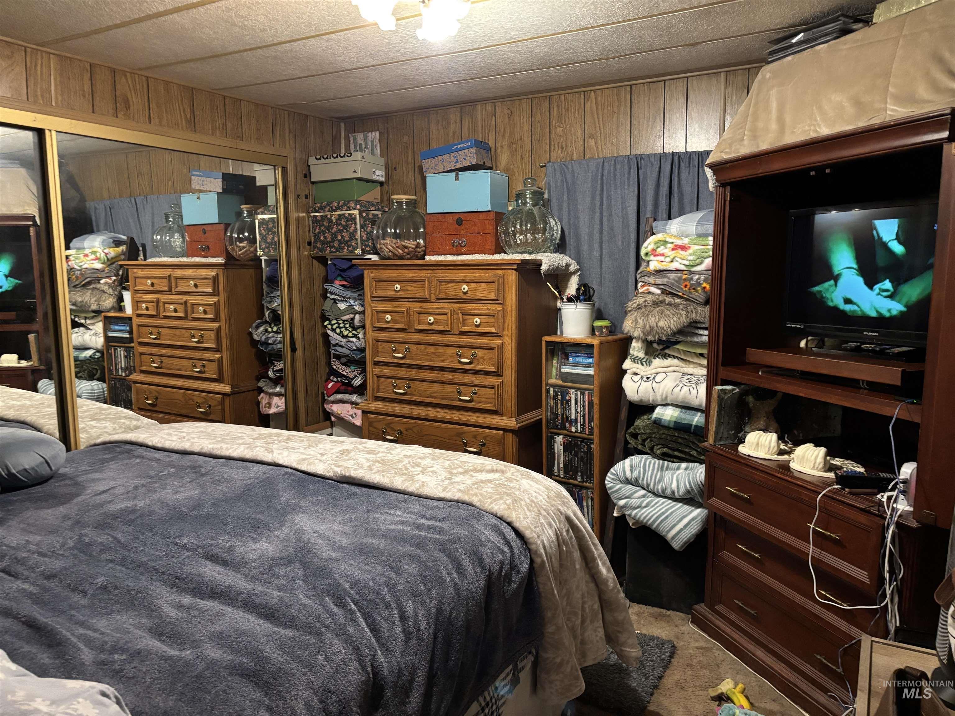 181 North Liberty Street Boise, ID 83704 - Photo 6 of 10 Bedroom with a closet, wood walls, carpet floors, and a paneled ceiling