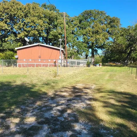 a view of a large yard with a large trees