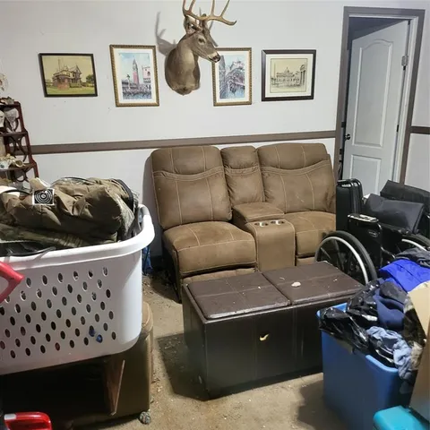 a living room with furniture and wall painting