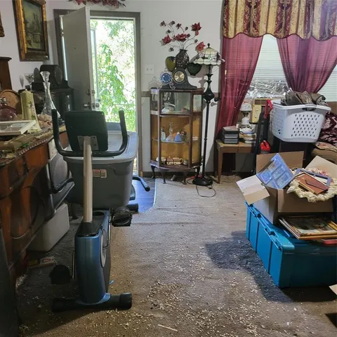 a living room with furniture a window and a fireplace