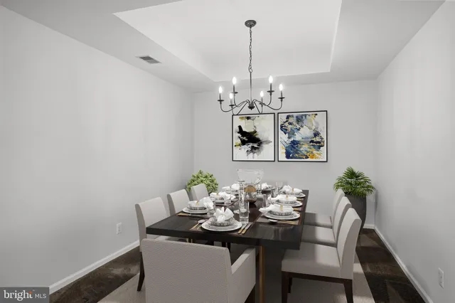 a view of a dining room with furniture and chandelier