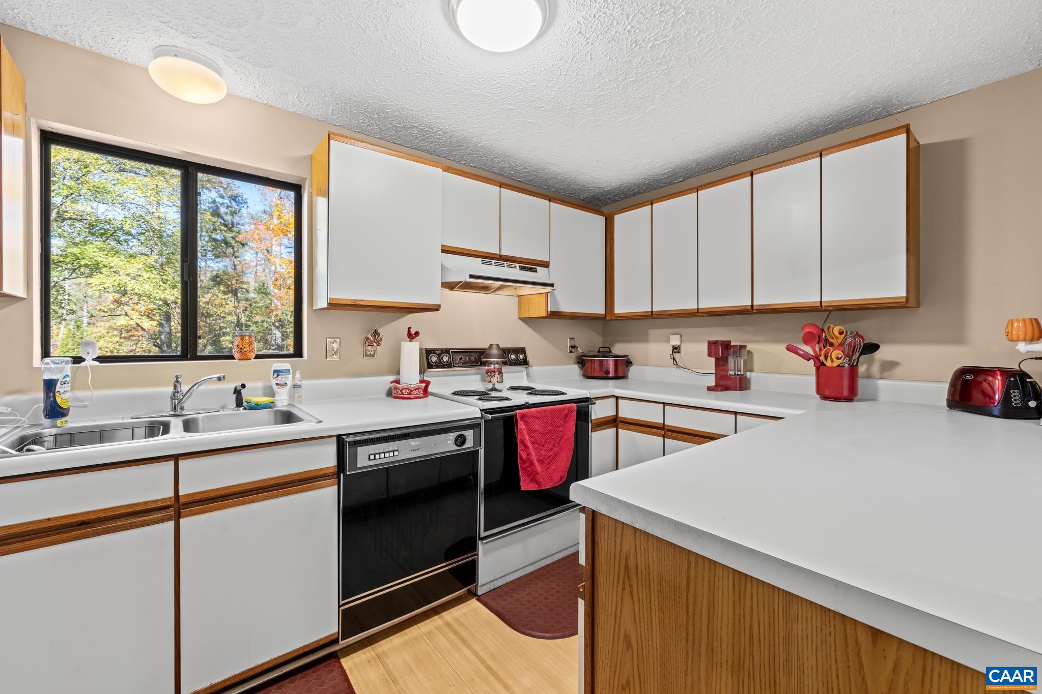 2530 Gillums Ridge Lane Charlottesville, VA 22903 - Photo 15 of 45 a kitchen with a sink stove top oven and cabinets