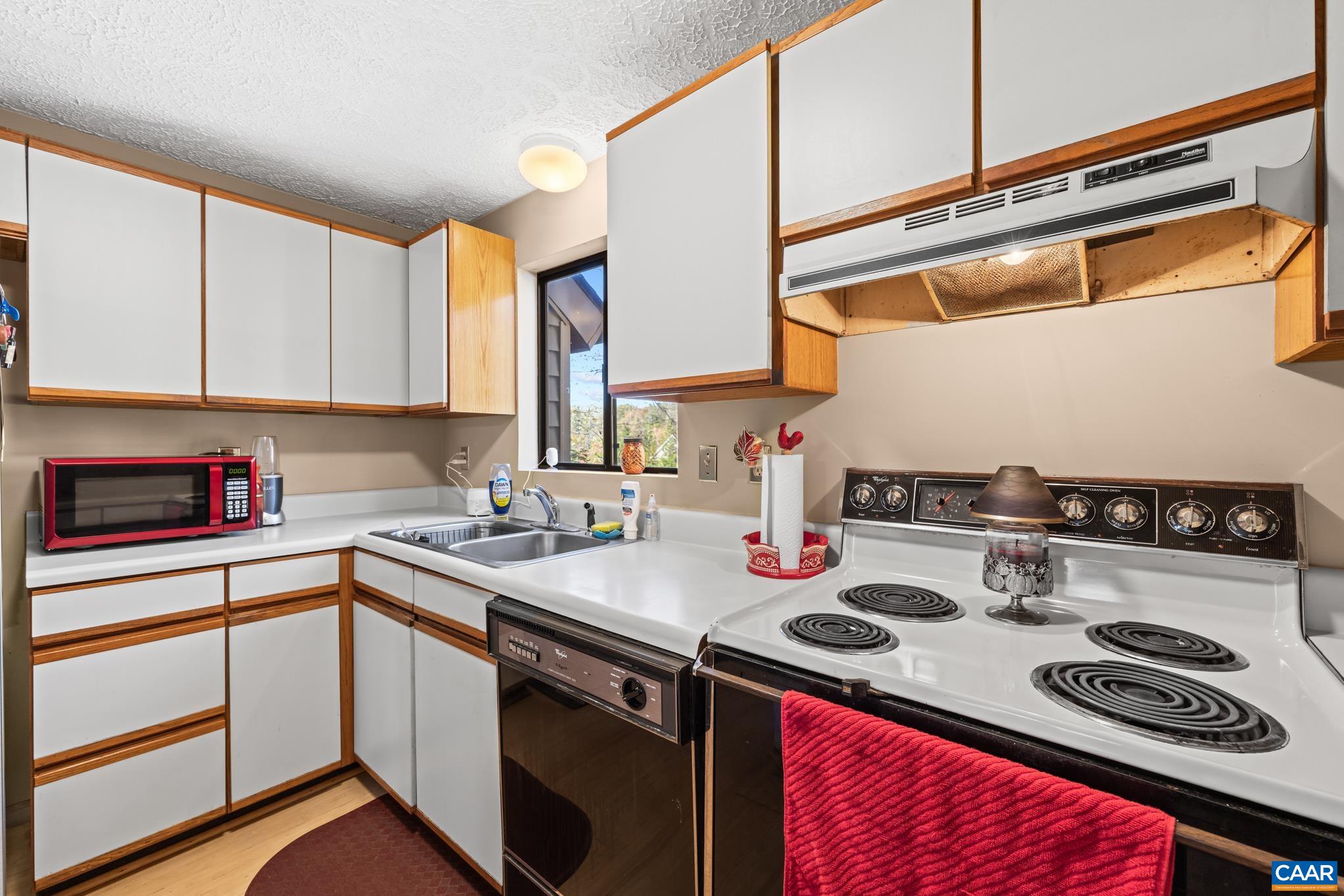 2530 Gillums Ridge Lane Charlottesville, VA 22903 - Photo 16 of 45 a kitchen with a sink a stove and cabinets