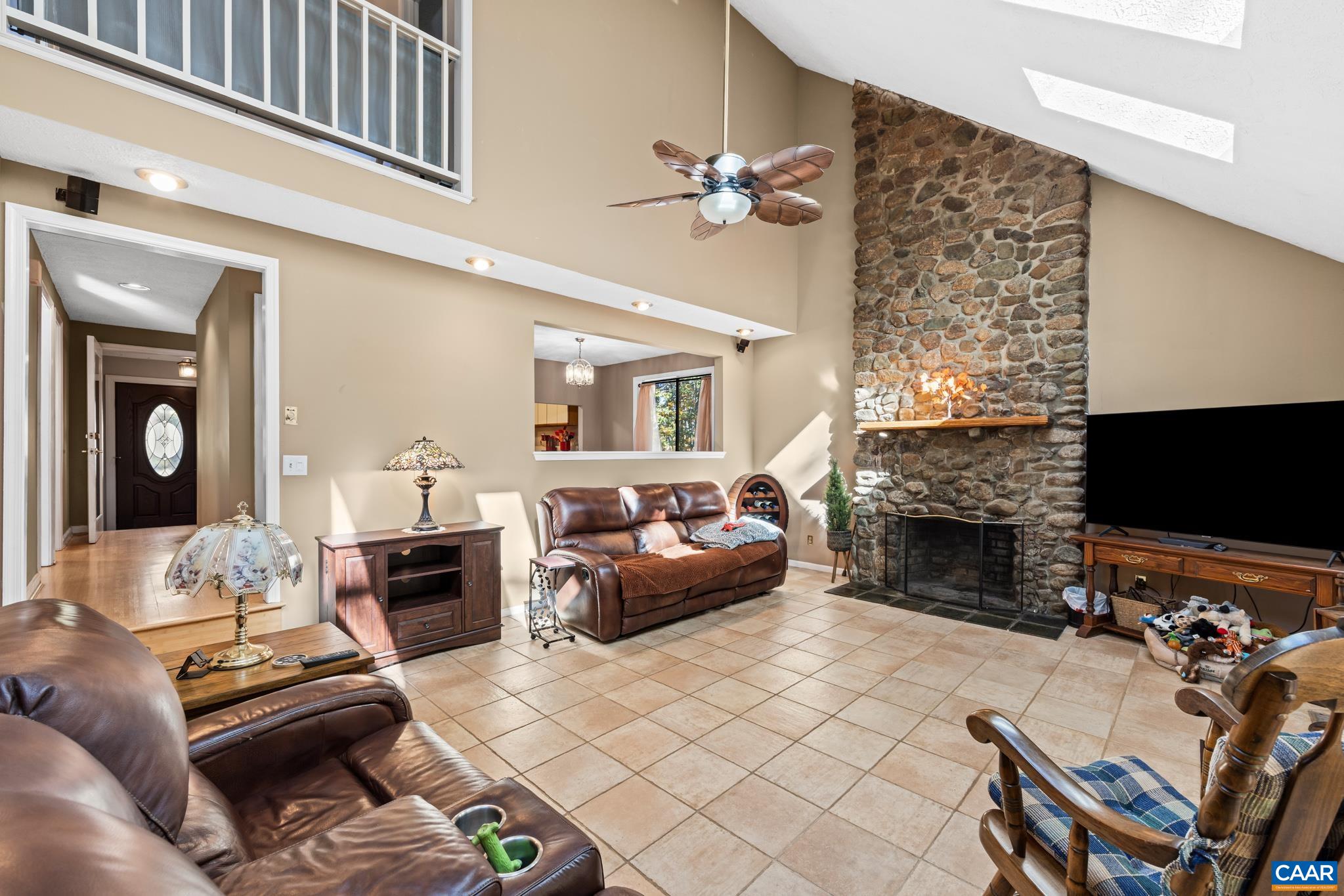 2530 Gillums Ridge Lane Charlottesville, VA 22903 - Photo 18 of 45 a living room with furniture a flat screen tv and a fireplace