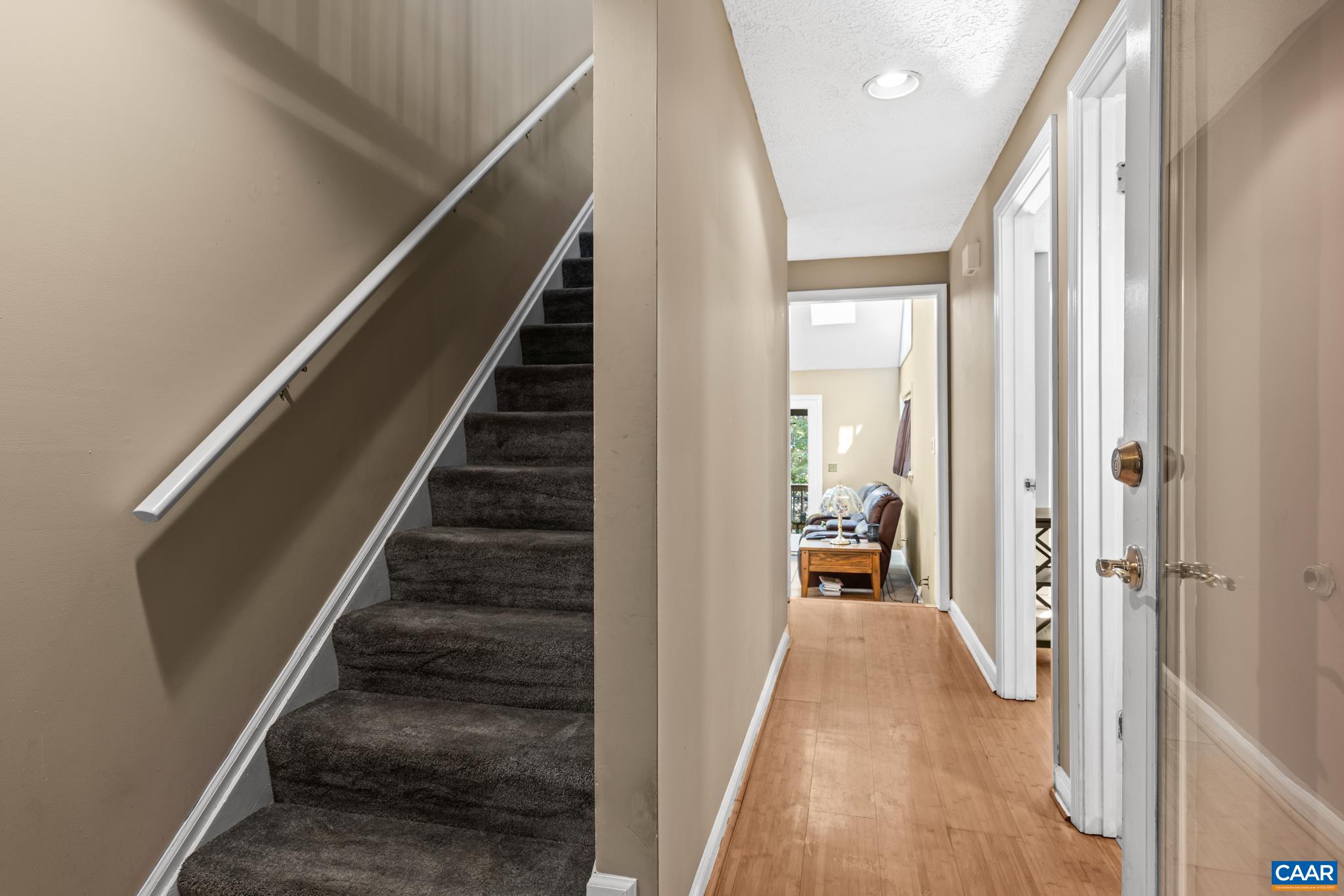 2530 Gillums Ridge Lane Charlottesville, VA 22903 - Photo 8 of 45 a view of a hallway to a livingroom with wooden floor and stairs