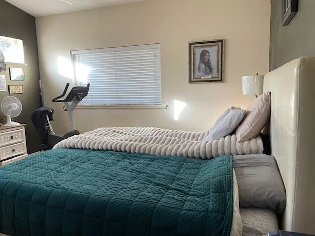 a bedroom with a bed window and couch