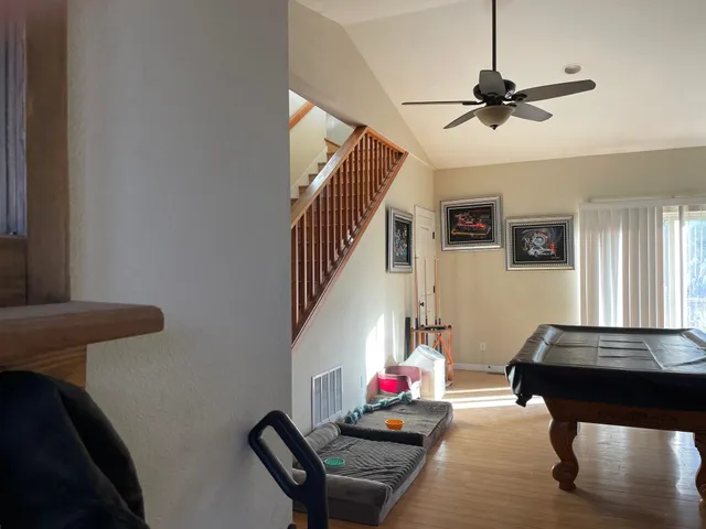 a living room with furniture and a ceiling fan
