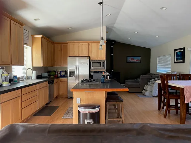 a kitchen with a table chairs refrigerator and cabinets