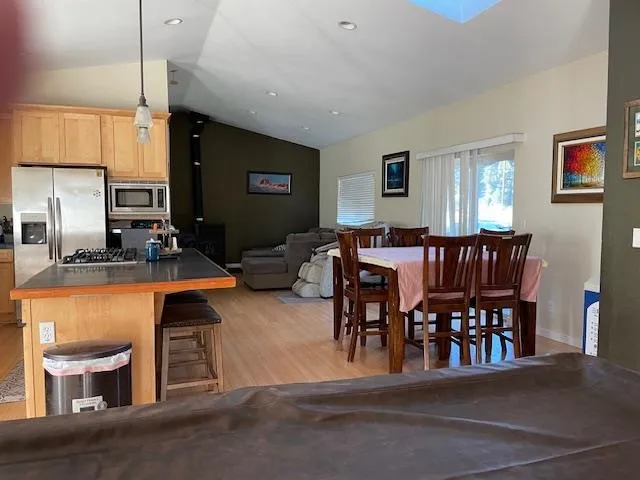 a dining room with furniture and wooden floor