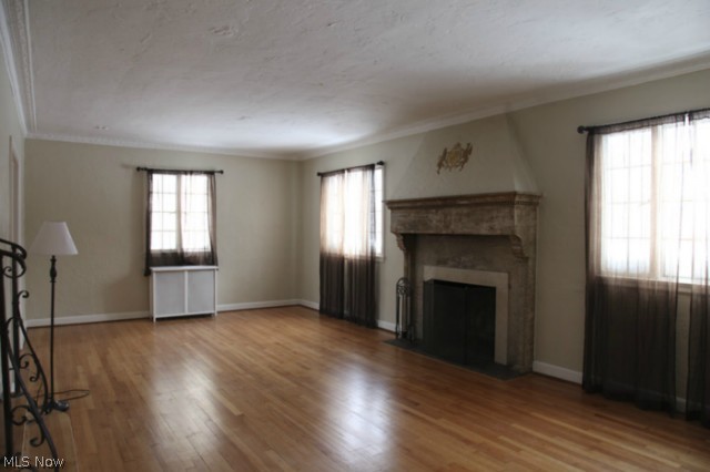 3712 Traynham Road Beachwood, OH 44122 - Photo 3 of 25 The formal living room is anchored by a substantial wood burning fireplace featuring carved mantle & surround of rope columns, dental molding details and crowned by a coate of arms plaster relief. Gleaming wood floors, stunning plaster crown molding & plaster walls & ceiling featuring architectural reliefs throughout the room, radiator cover & abundance of light. Simply magnificent.