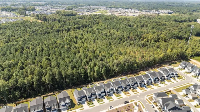an aerial view of a residential apartment building with a yard