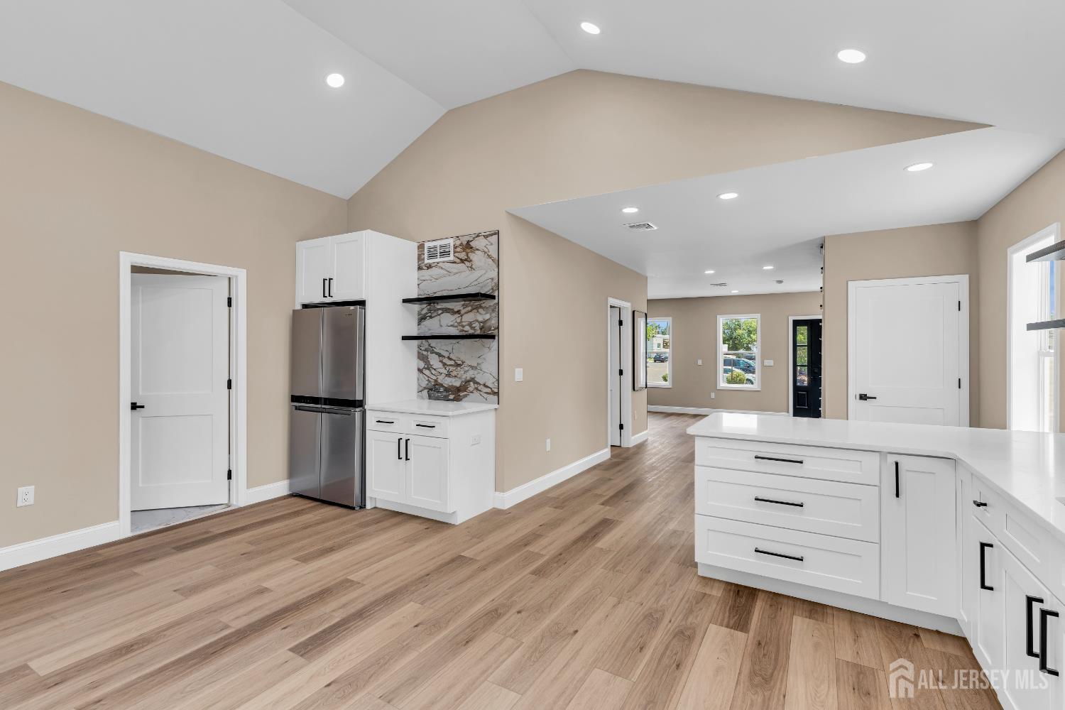 21 Harrison Avenue Englishtown, NJ 07726 - Photo 14 of 34 a kitchen with stainless steel appliances white cabinets and wooden floor