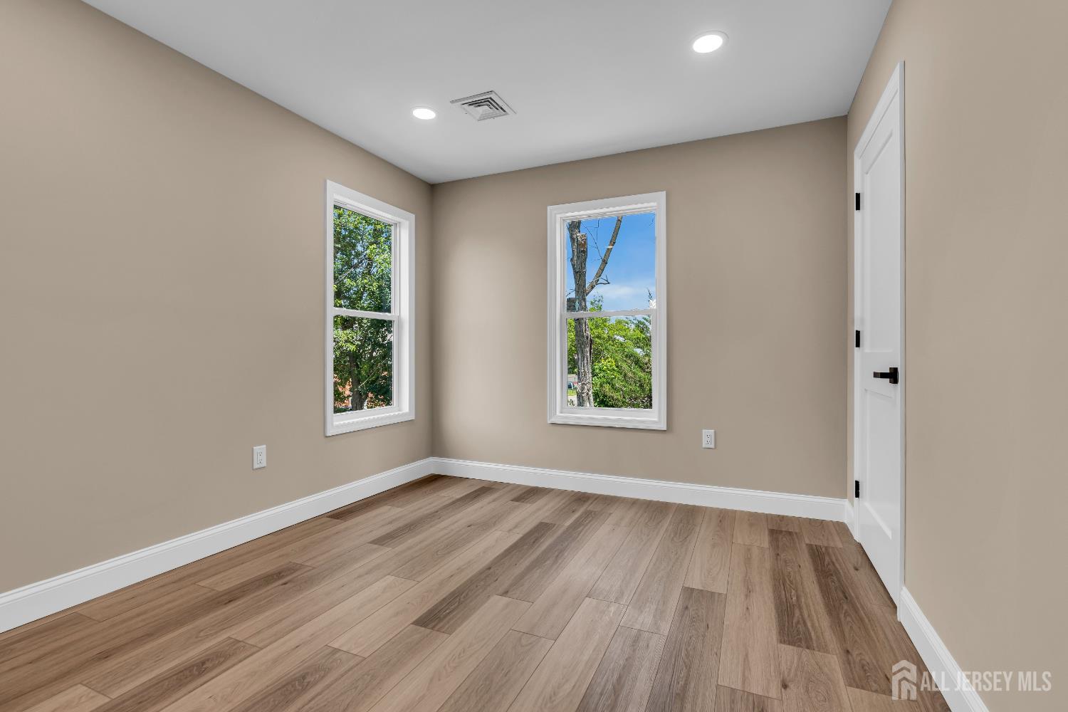 21 Harrison Avenue Englishtown, NJ 07726 - Photo 26 of 34 an empty room with wooden floor and windows