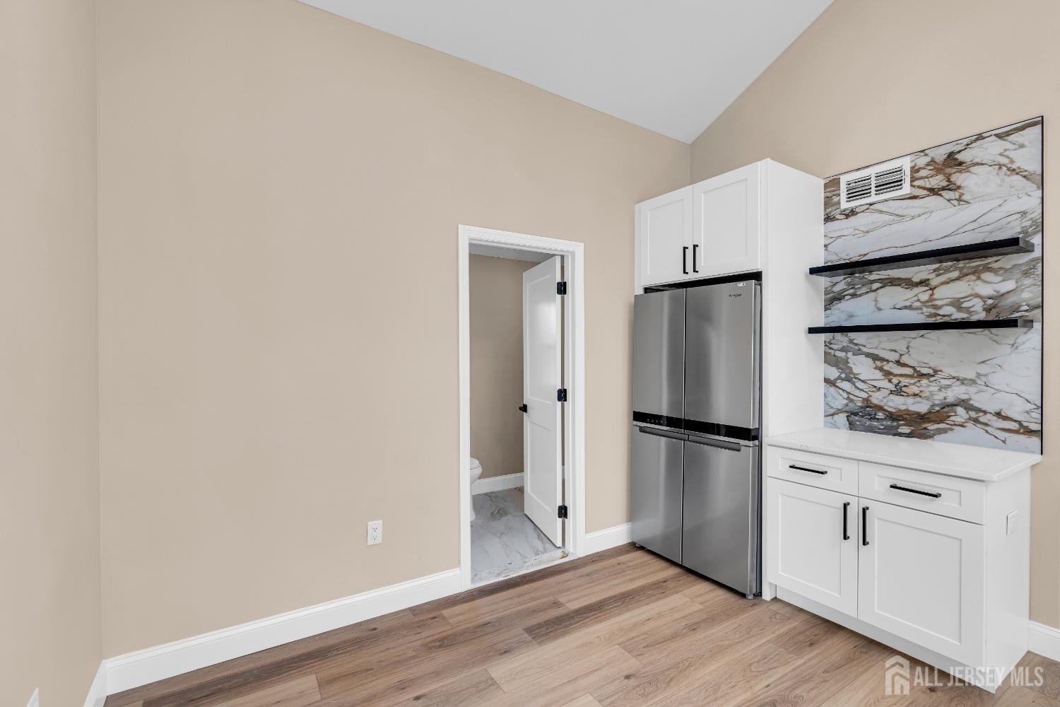 21 Harrison Avenue Englishtown, NJ 07726 - Photo 31 of 34 a kitchen with a refrigerator and white cabinets