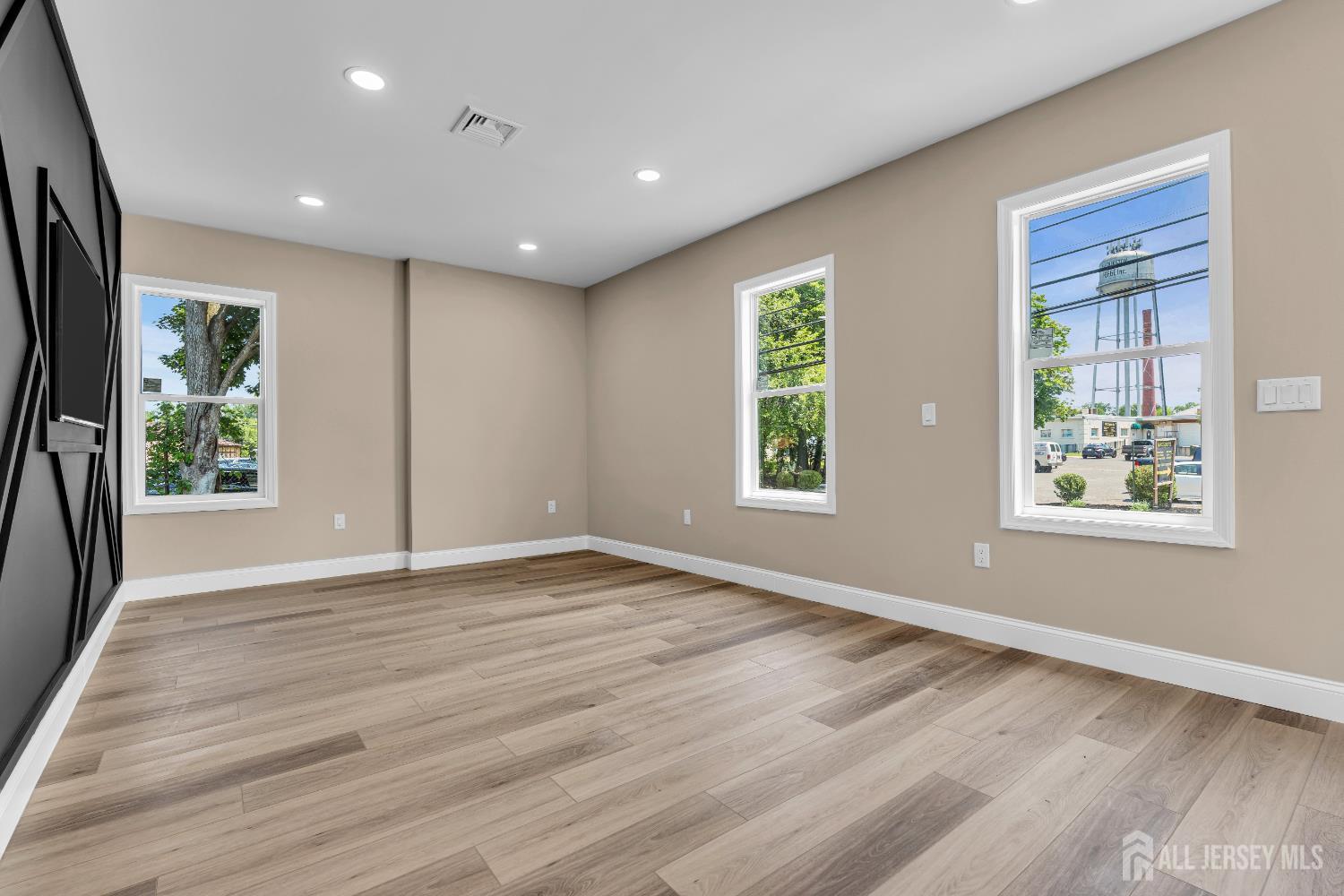 21 Harrison Avenue Englishtown, NJ 07726 - Photo 4 of 34 a view of an empty room with wooden floor and a window