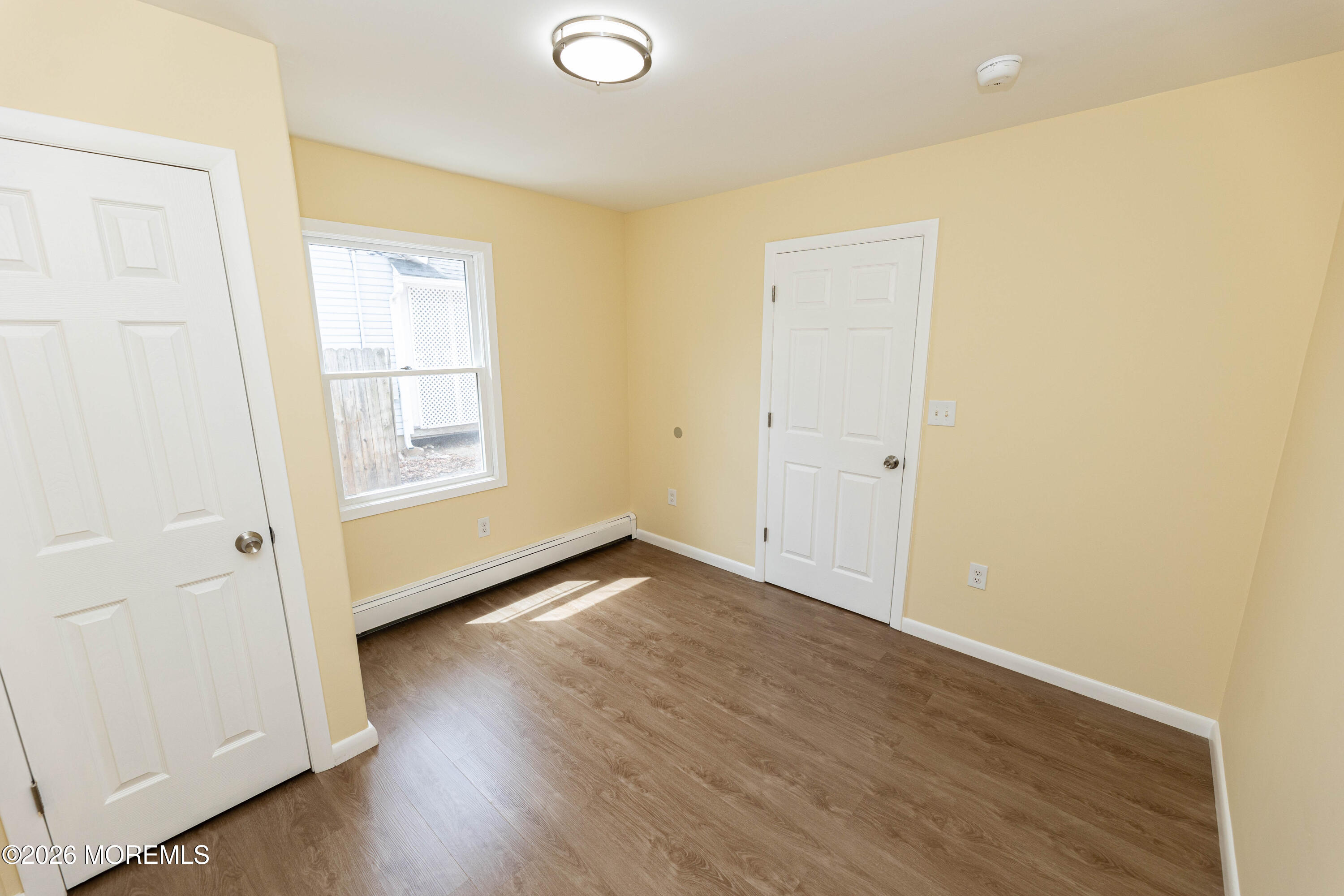 2408 Herbertsville Road Point Pleasant, NJ 08742 - Photo 51 of 82 an empty room with wooden floor and windows