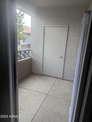 an empty room with an entrance to other room