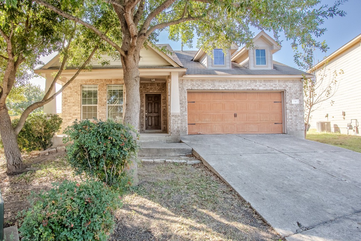 236 Caddis Cove Kyle, TX 78640 - Photo 1 of 17 front view of a house with a yard and an trees