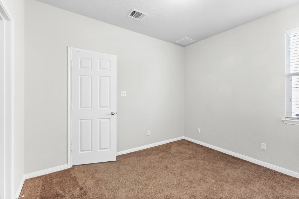 236 Caddis Cove Kyle, TX 78640 - Photo 12 of 17 an empty room with a empty space and windows