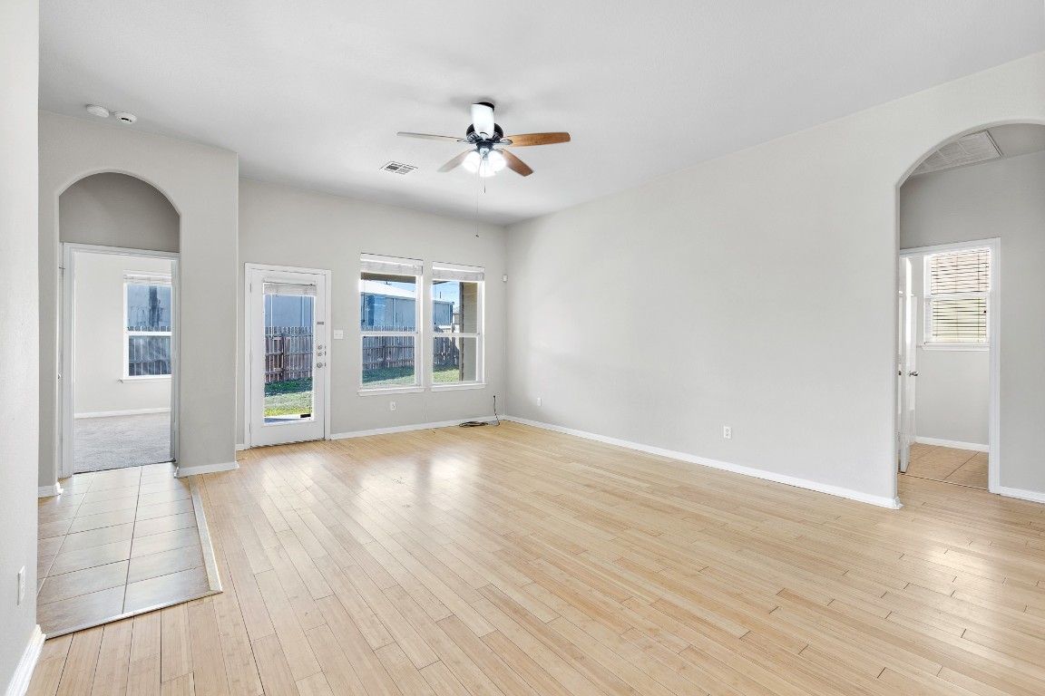 236 Caddis Cove Kyle, TX 78640 - Photo 2 of 17 wooden floor in an empty room with a window