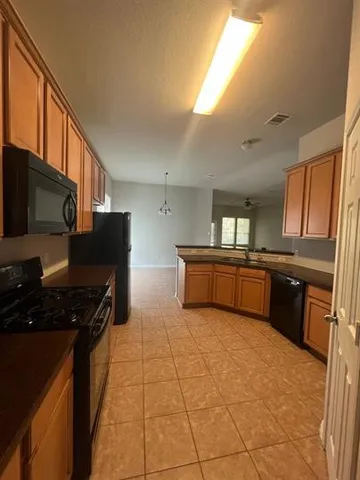 a kitchen with granite countertop a stove and a refrigerator