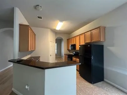 a kitchen with a refrigerator and a stove