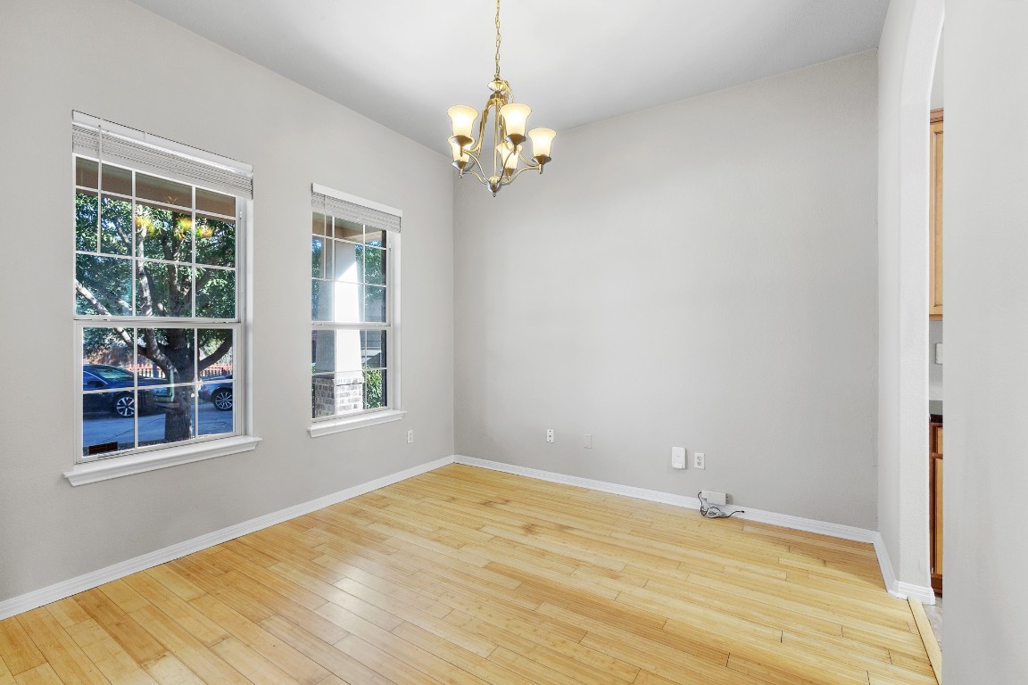 236 Caddis Cove Kyle, TX 78640 - Photo 5 of 17 a view of wooden floor and chandelier in a room