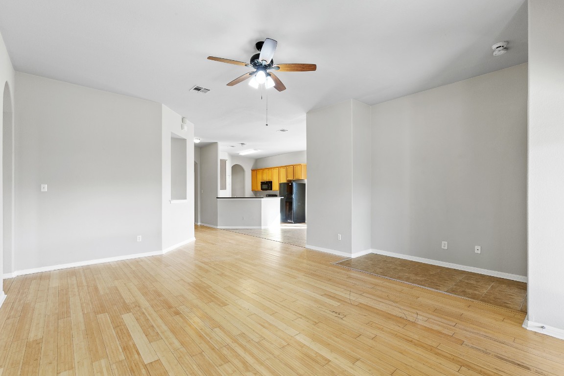 236 Caddis Cove Kyle, TX 78640 - Photo 6 of 17 a view of a room with wooden floor and ceiling fan