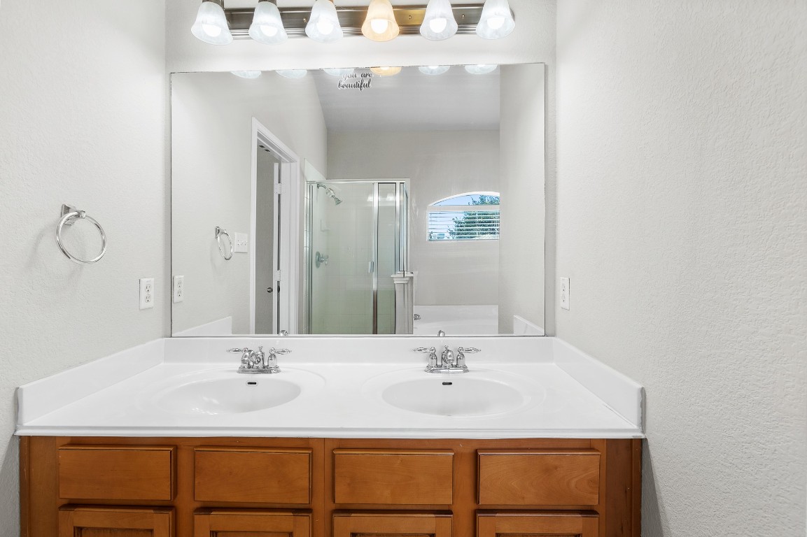236 Caddis Cove Kyle, TX 78640 - Photo 9 of 17 a bathroom with a sink vanity and mirror