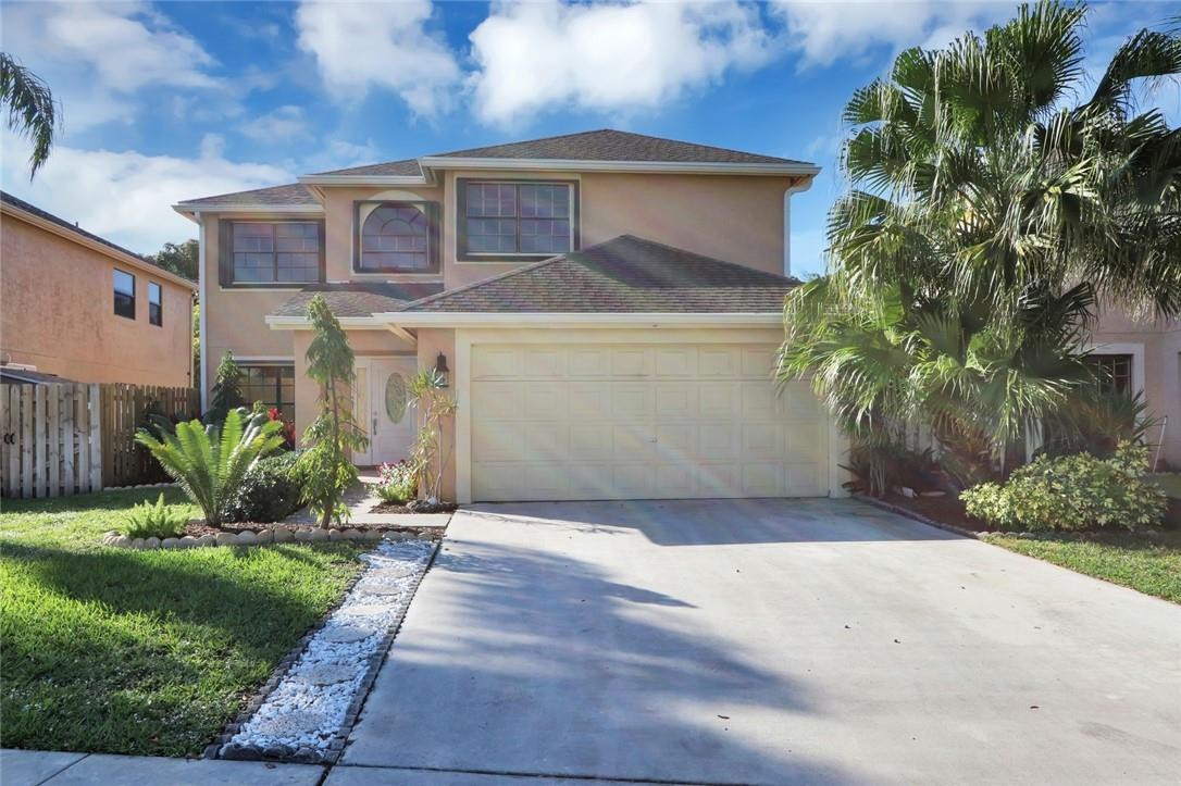 22933 Old Inlet Bridge Drive Boca Raton, FL 33433 - Photo 2 of 26 a front view of a house with a yard