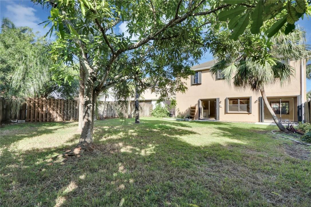 22933 Old Inlet Bridge Drive Boca Raton, FL 33433 - Photo 5 of 26 a view of a yard with a house and a tree