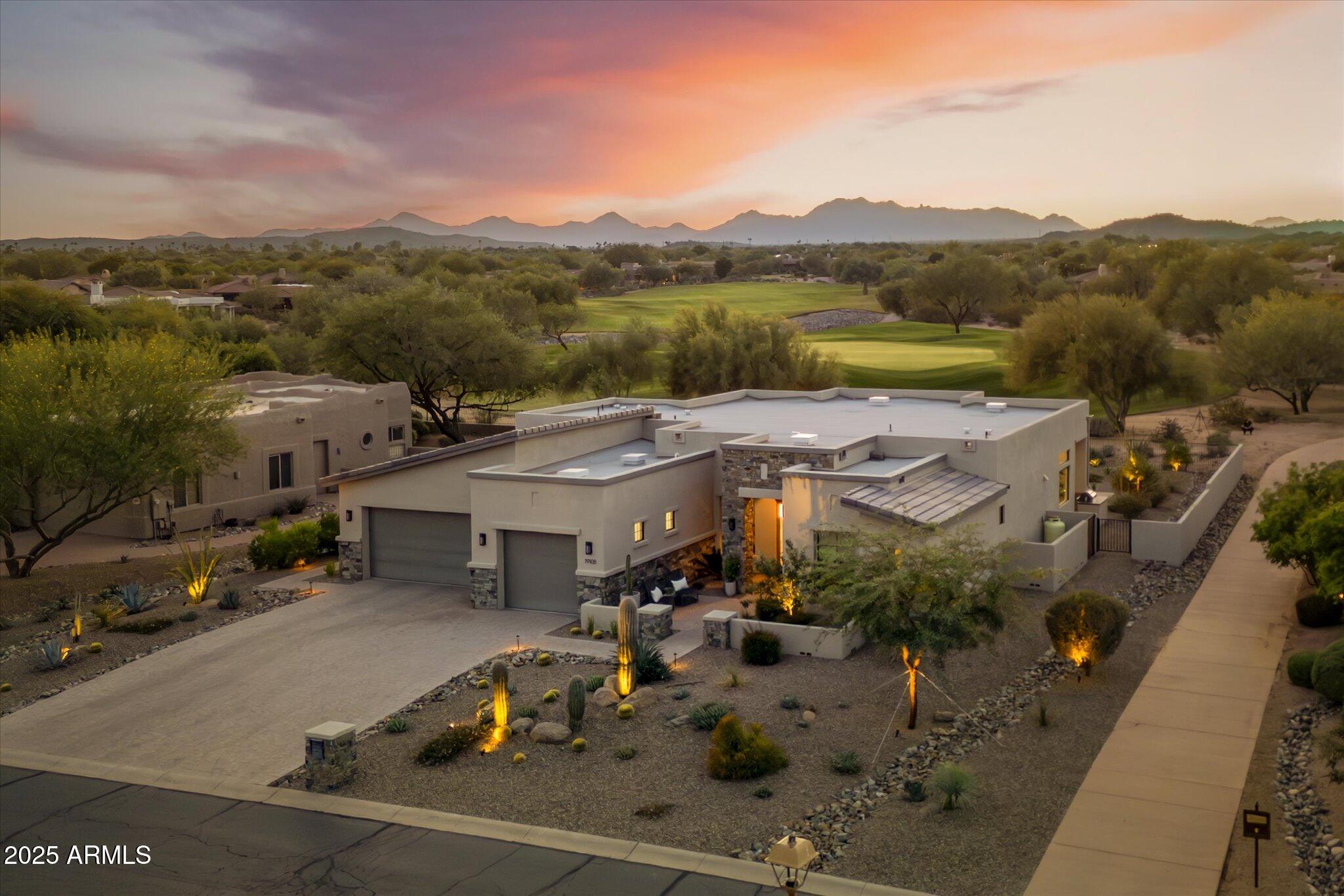 an aerial view of a house with a garden and lake view