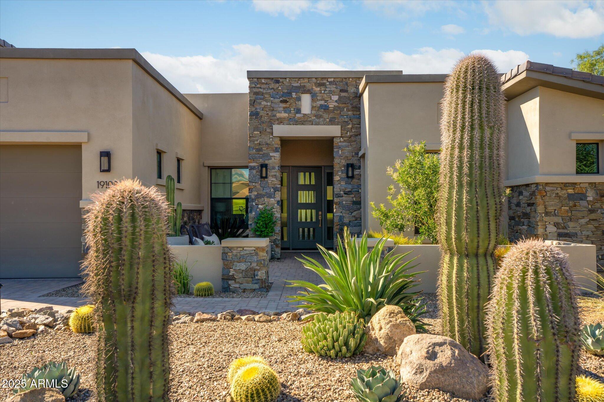 19108 East Tonto Verde Drive Rio Verde, AZ 85263 - Photo 2 of 46 a potted plant sitting in front of a house