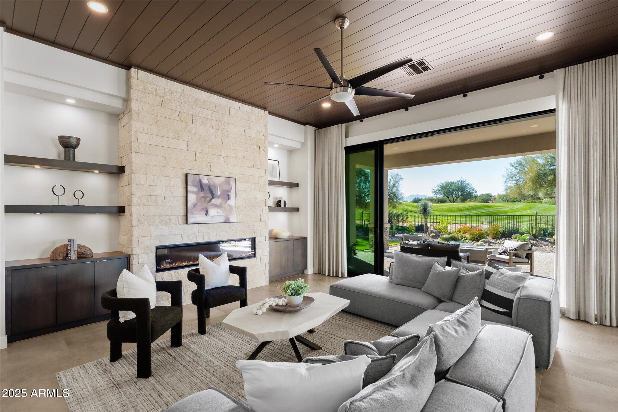 19108 East Tonto Verde Drive Rio Verde, AZ 85263 - Photo 3 of 46 a living room with furniture a ceiling fan and a large window
