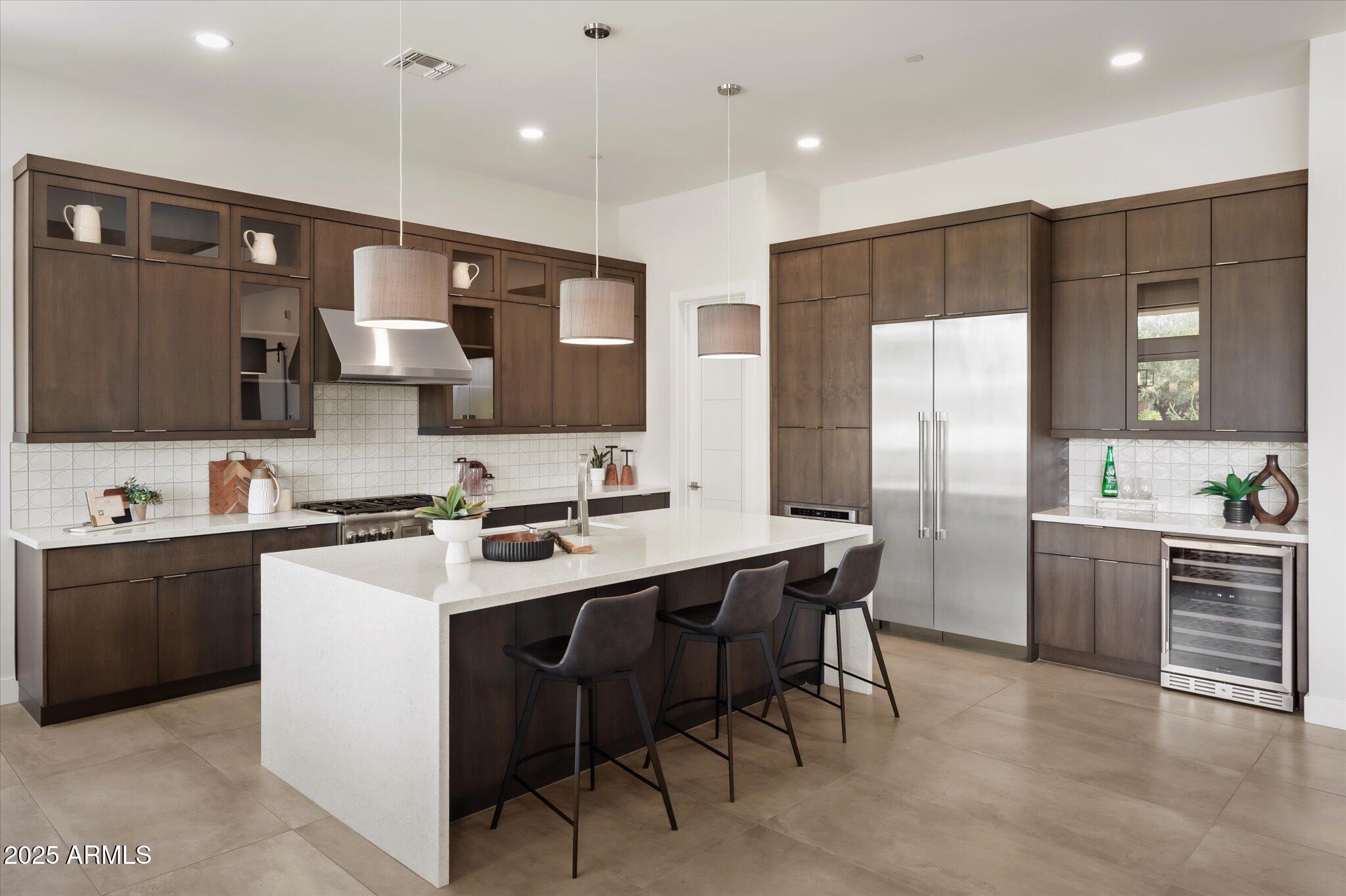 19108 East Tonto Verde Drive Rio Verde, AZ 85263 - Photo 9 of 46 a kitchen with stainless steel appliances a sink a stove a refrigerator and cabinets