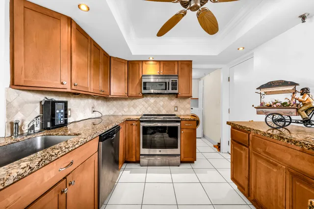 a kitchen with stainless steel appliances granite countertop a stove and a sink