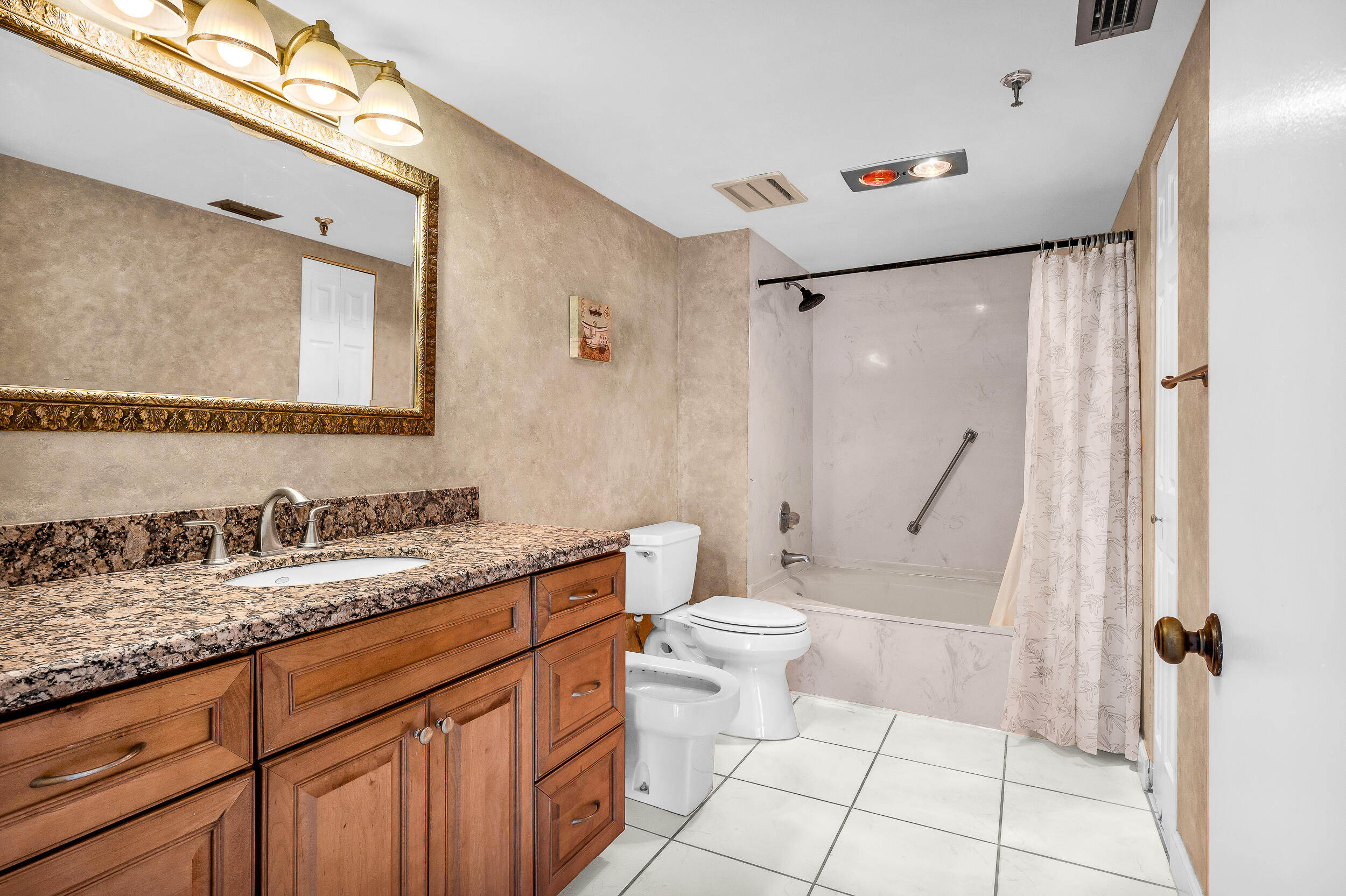 5340 Northwest 2nd Avenue, Unit 323 Boca Raton, FL 33487 - Photo 11 of 21 a bathroom with a granite countertop sink toilet and shower
