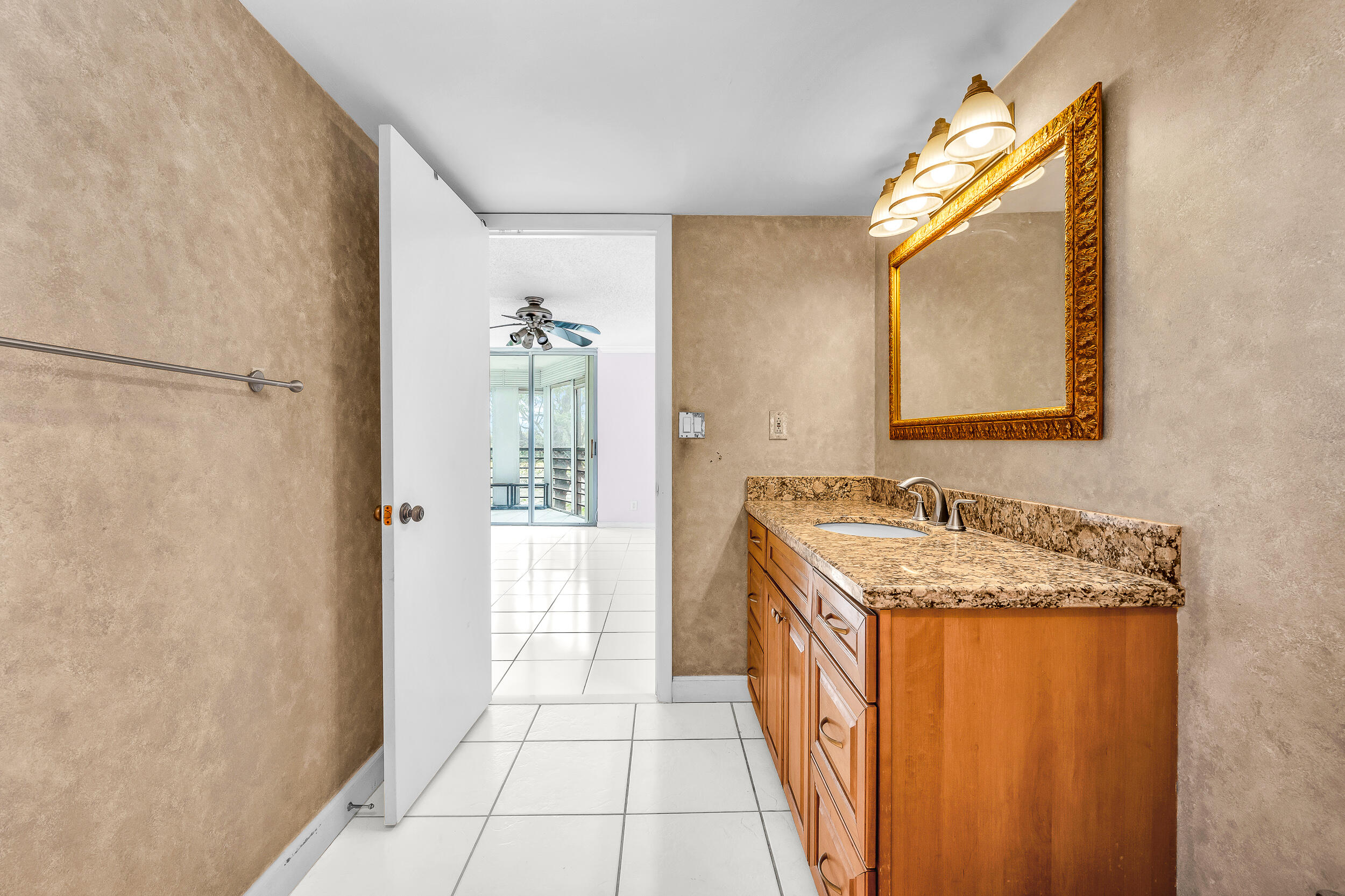 5340 Northwest 2nd Avenue, Unit 323 Boca Raton, FL 33487 - Photo 12 of 21 a bathroom with a granite countertop sink and a mirror