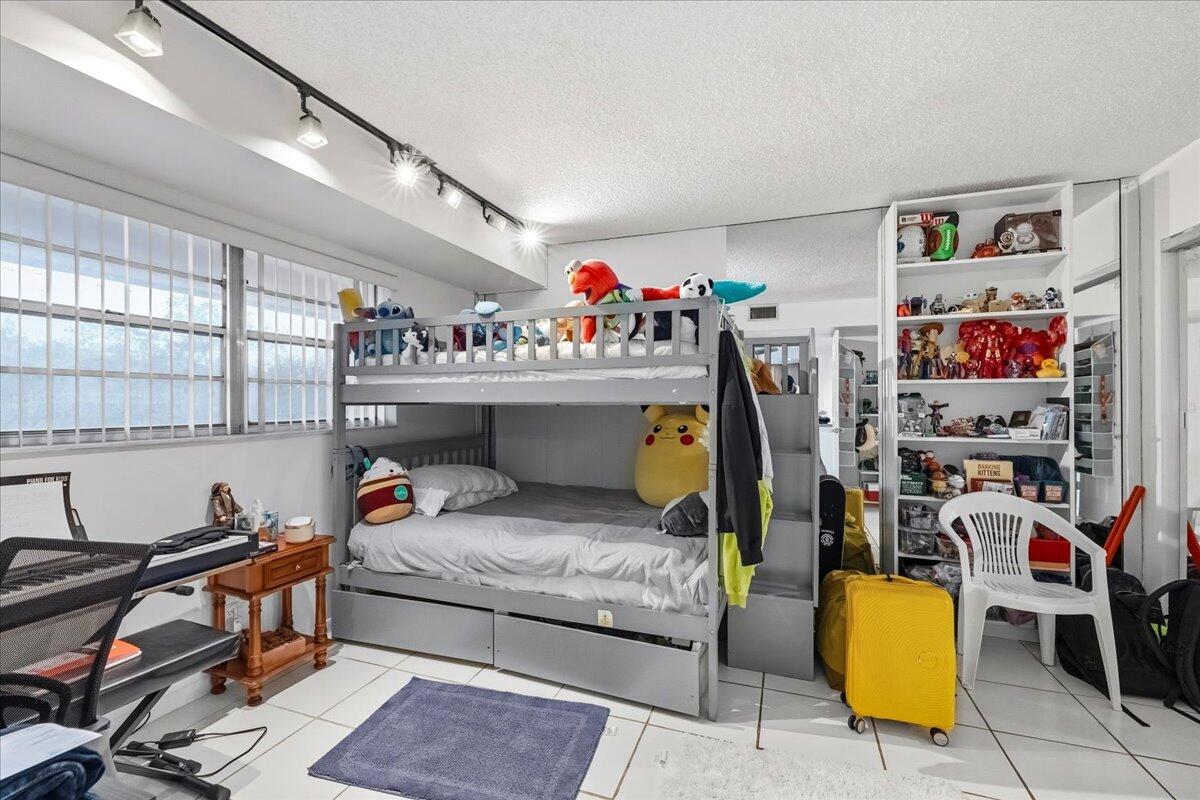 5340 Northwest 2nd Avenue, Unit 323 Boca Raton, FL 33487 - Photo 14 of 21 a bedroom with furniture and a bed