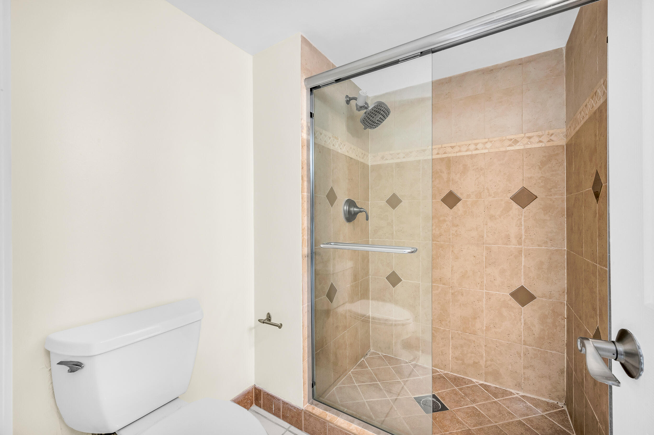 5340 Northwest 2nd Avenue, Unit 323 Boca Raton, FL 33487 - Photo 17 of 21 a bathroom with a shower and toilet