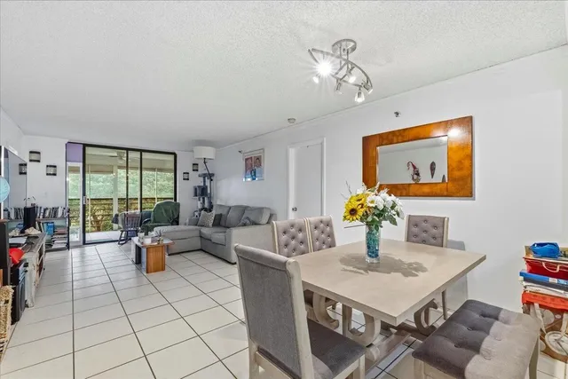 a living room with fireplace furniture and a large window