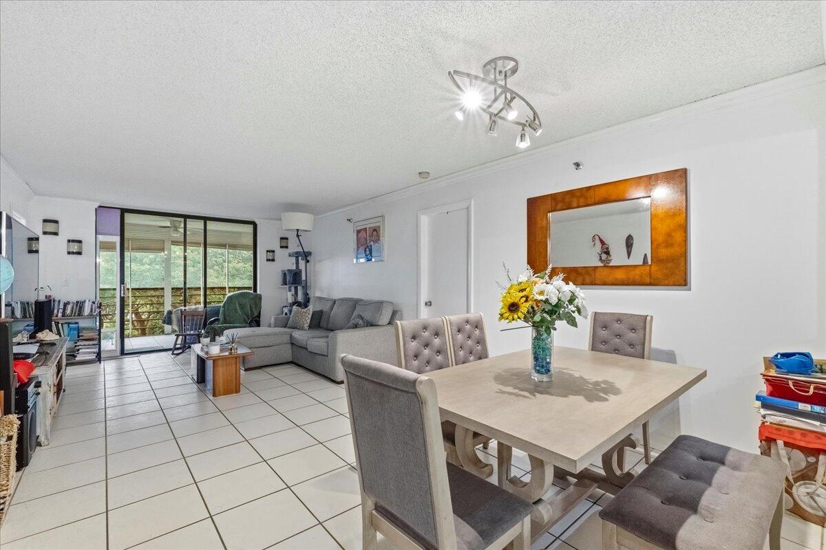 5340 Northwest 2nd Avenue, Unit 323 Boca Raton, FL 33487 - Photo 6 of 21 a living room with fireplace furniture and a large window