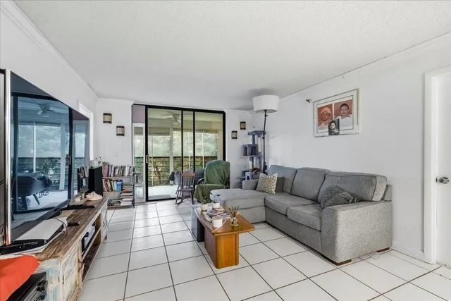 a living room with furniture and a floor to ceiling window