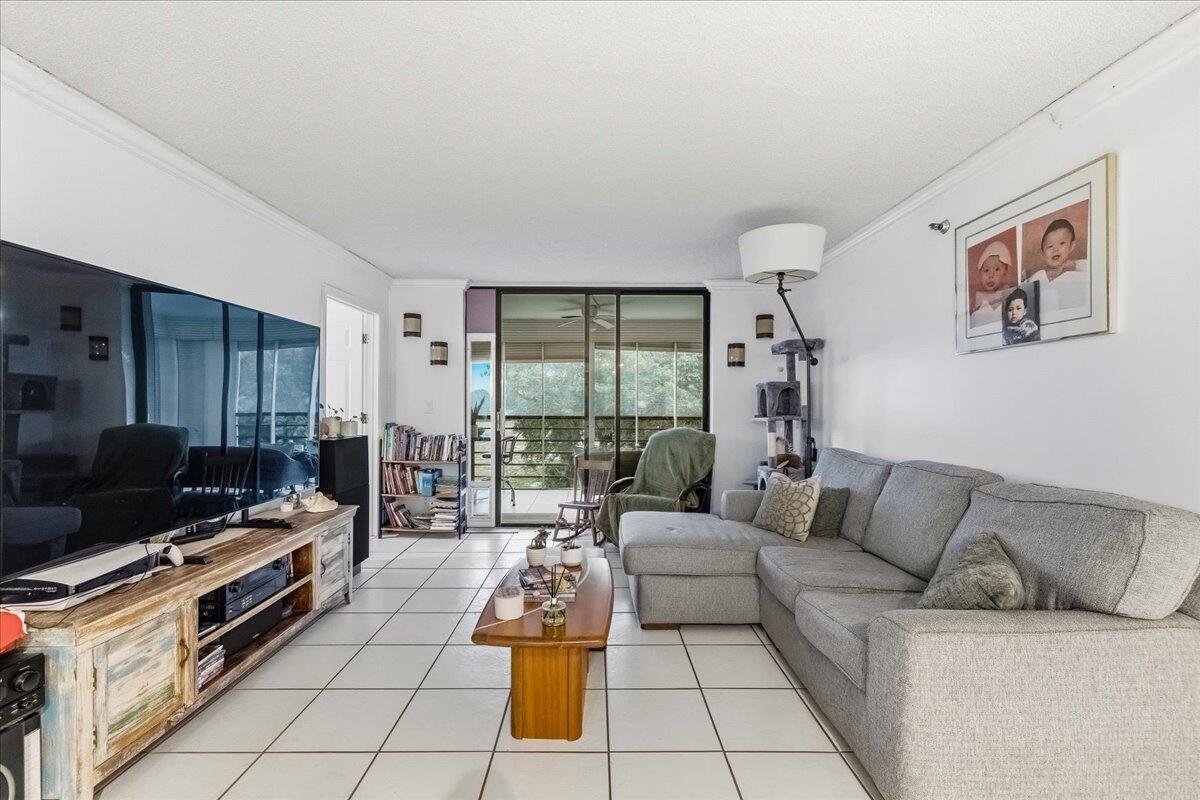 5340 Northwest 2nd Avenue, Unit 323 Boca Raton, FL 33487 - Photo 8 of 21 a living room with furniture and a flat screen tv