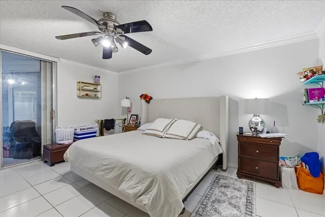 a bedroom with a bed and ceiling fan