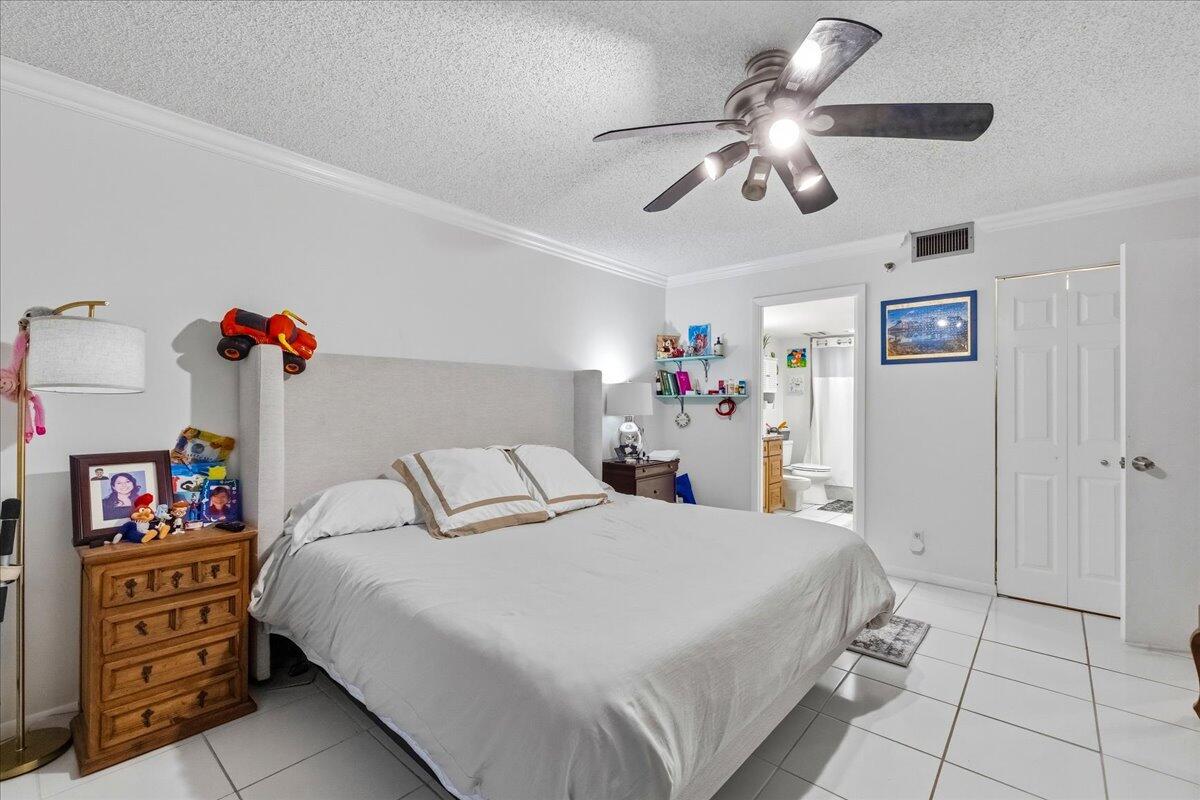 5340 Northwest 2nd Avenue, Unit 323 Boca Raton, FL 33487 - Photo 10 of 21 a bedroom with a bed and a cabinets