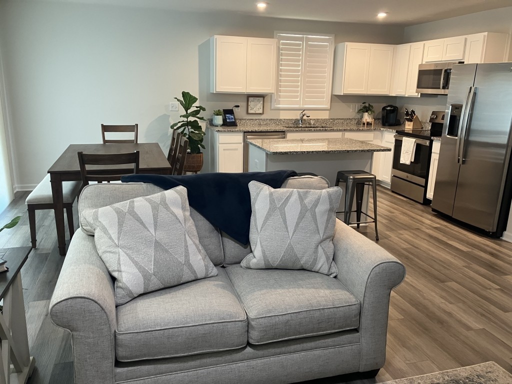 2315 Burnwick Grove Spring Hill, TN 37174 - Photo 2 of 13 a living room with furniture white wooden floor and a view of kitchen